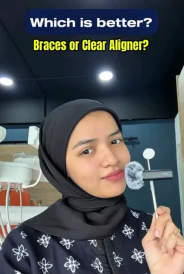 Dentist explaining braces versus clear aligners in Kuala Lumpur